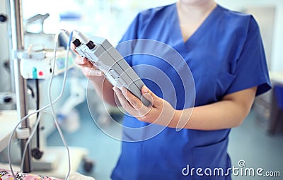 Female doctor adjust electronic medical device Stock Photo