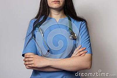 Female doctor in blue medical uniform with stethoscope on her neck Stock Photo