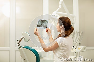 Female doctor or dentist looking at x-ray. Healthcare, medical and radiology concept Stock Photo