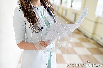 Female doctor with documents and stethoscope in hospital Stock Photo