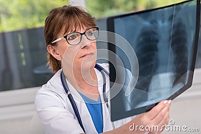 Female doctor examining x-ray report Stock Photo