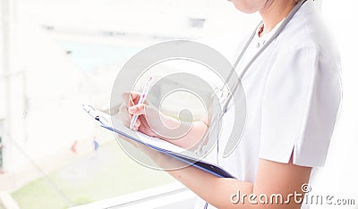 Female doctor filling up medical form on clipboard. Healthcare, Medical concept Stock Photo