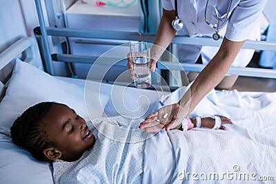 Female doctor giving medicine to patient Stock Photo