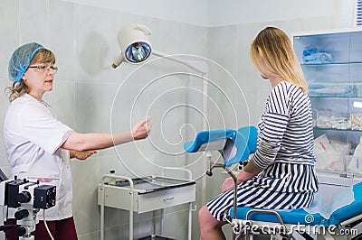 Female doctor gynecologist with patient at her office Stock Photo