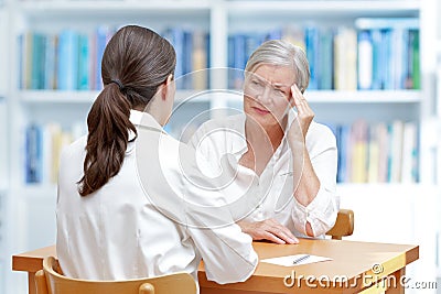 Doctor senior patient headache migraine Stock Photo