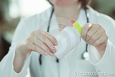 Female doctor holding bottle of dietary supplement Stock Photo