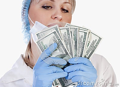 Female doctor holding money Stock Photo