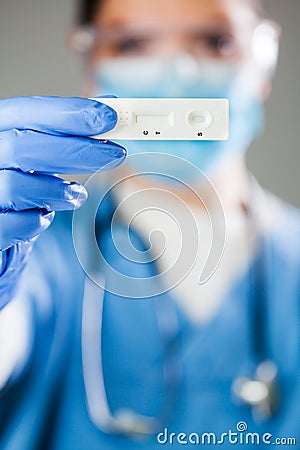 Female doctor holding Rapid Diagnostic Test serological test kit Stock Photo