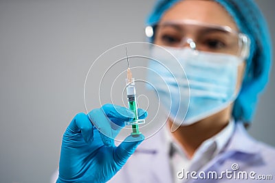 Doctor holding syringe with Coronavirus Covid-19 vaccine for injection test Stock Photo