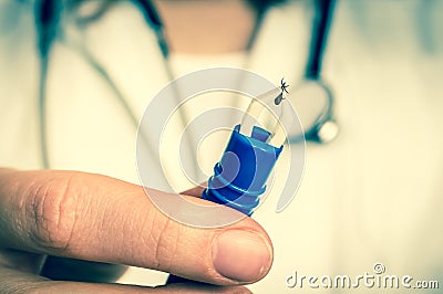 Female doctor is holding tweezers with a tick - retro style Stock Photo