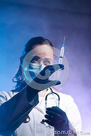 Female doctor is holding vaccine against desease Stock Photo