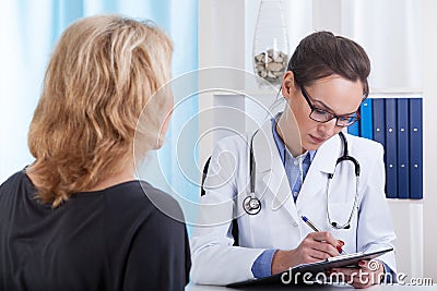 Female doctor making notes Stock Photo