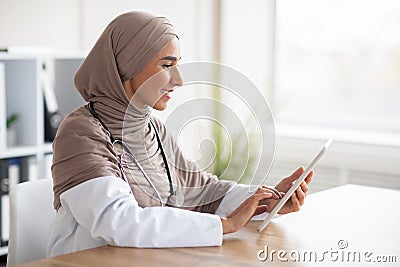 Female doctor muslim woman using digita tablet Stock Photo