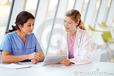 Female Doctor And Nurse Having Meeting Stock Photo