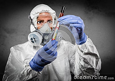 Female Doctor or Nurse In Hazmat Gear Holding Positive Coronavirus Test Tube Stock Photo