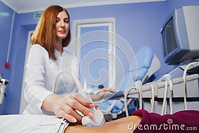 Female doctor operating ultrasound scanner Editorial Stock Photo