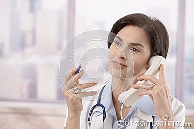 Female doctor on the phone Stock Photo
