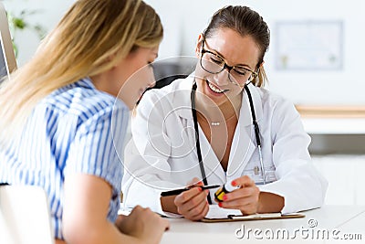 Female doctor prescribing medication for patient. Stock Photo