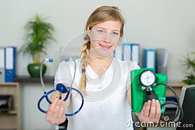 female doctor showing stethoscope and blood meassuring tool Stock Photo