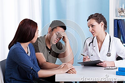 Female doctor talking with her patients Stock Photo