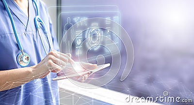 Female doctor touching a tablet displaying the patient`s data hologram Stock Photo