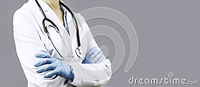 Female Doctors crossed hands. No face. grey background Stock Photo