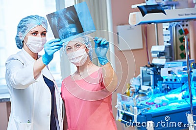 Female doctors in front of intensive care unit for newborn baby Stock Photo