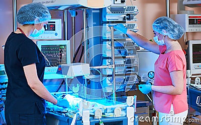 Female doctors in front of intensive care unit for newborn infant baby Stock Photo