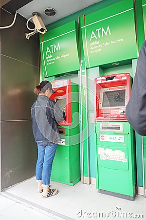 Female doing Kasikorn Bank automatic teller machine Editorial Stock Photo