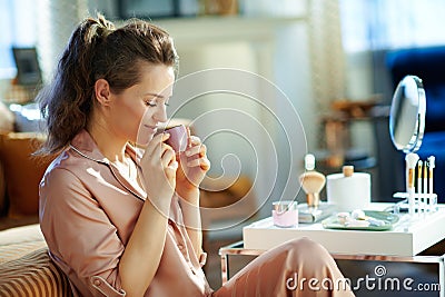 Female drinking espresso at modern home in sunny winter day Stock Photo