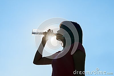 Female drinking water in hot summer - heat stroke concept. Stock Photo