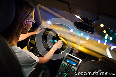 Female drive driving a car at night Stock Photo