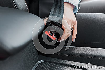 Female driver fastens seat belt close-up Stock Photo