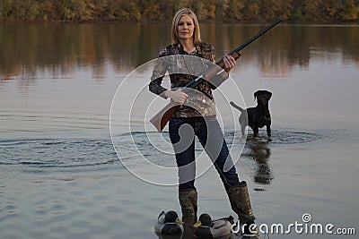 Female Duck Hunter with her Labrador Retriever Stock Photo