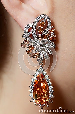 Female ear in jewelry earrings Stock Photo