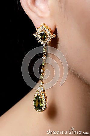 Female ear in jewelry earrings Stock Photo