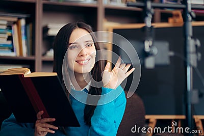 Female Educator Teaching Online Course Holding a Book Stock Photo