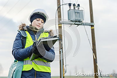 Female electrical engineer finishing checking high voltage line Stock Photo