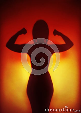 Female empowerment concept silhouette of a strong woman flexing muscles Stock Photo