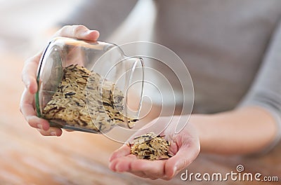 Female emptying jar with white and wild black rice Stock Photo