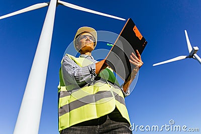 Female energy engineer works with wind turbines Stock Photo