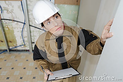 Female engineer studying building wall Stock Photo