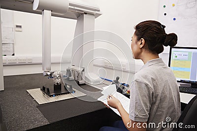 Female Engineer Uses CMM Coordinate Measuring Machine In Factory Stock Photo