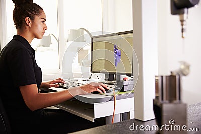 Female Engineer Using CAD System To Work On Component Stock Photo