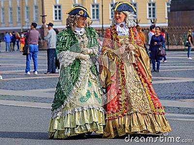 Female entertainers in period dresses awaiting tourists by the Hermitage Winter Palace on Palace Square Saint Petersburg, Russia Editorial Stock Photo