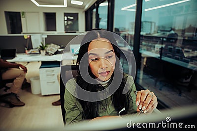 female entrepreneur removing glasses after long day at work feeling tired and anxious sitting in office Stock Photo