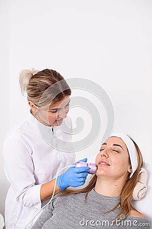 Female esthetician performs a cryotherapy procedure in a beauty salon Stock Photo