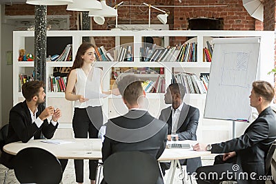 Female executive coaching group of corporate employees during br Stock Photo