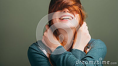 Female expressing joy toothy smile messing hair Stock Photo