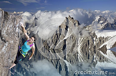 Female extreme climber hanging on cliff over the Stock Photo